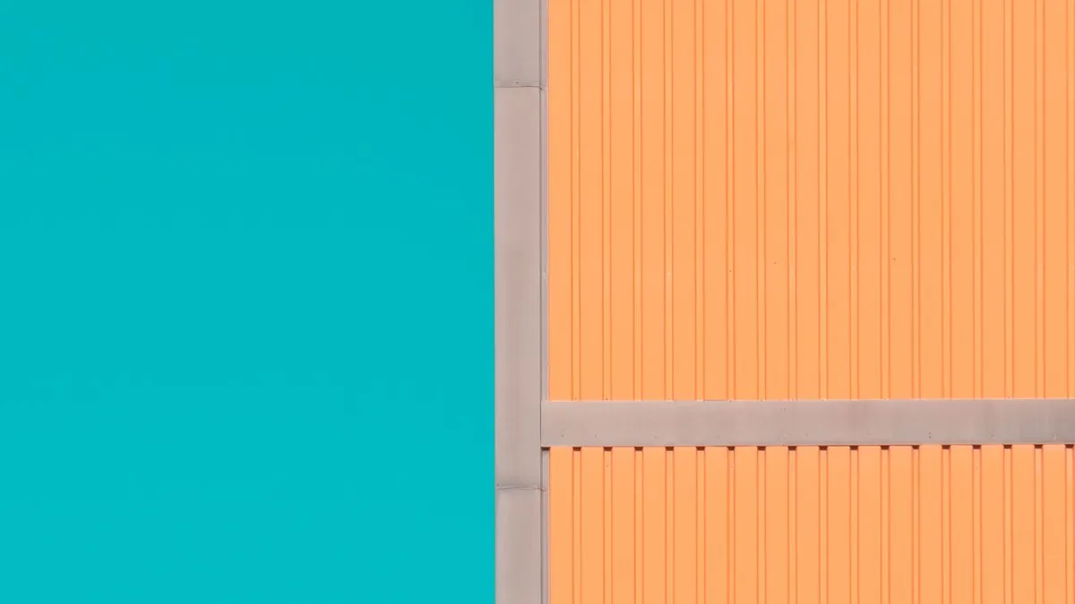 A vibrant, minimalist architectural facade featuring color contrast between orange and teal in Oslo, Norway.