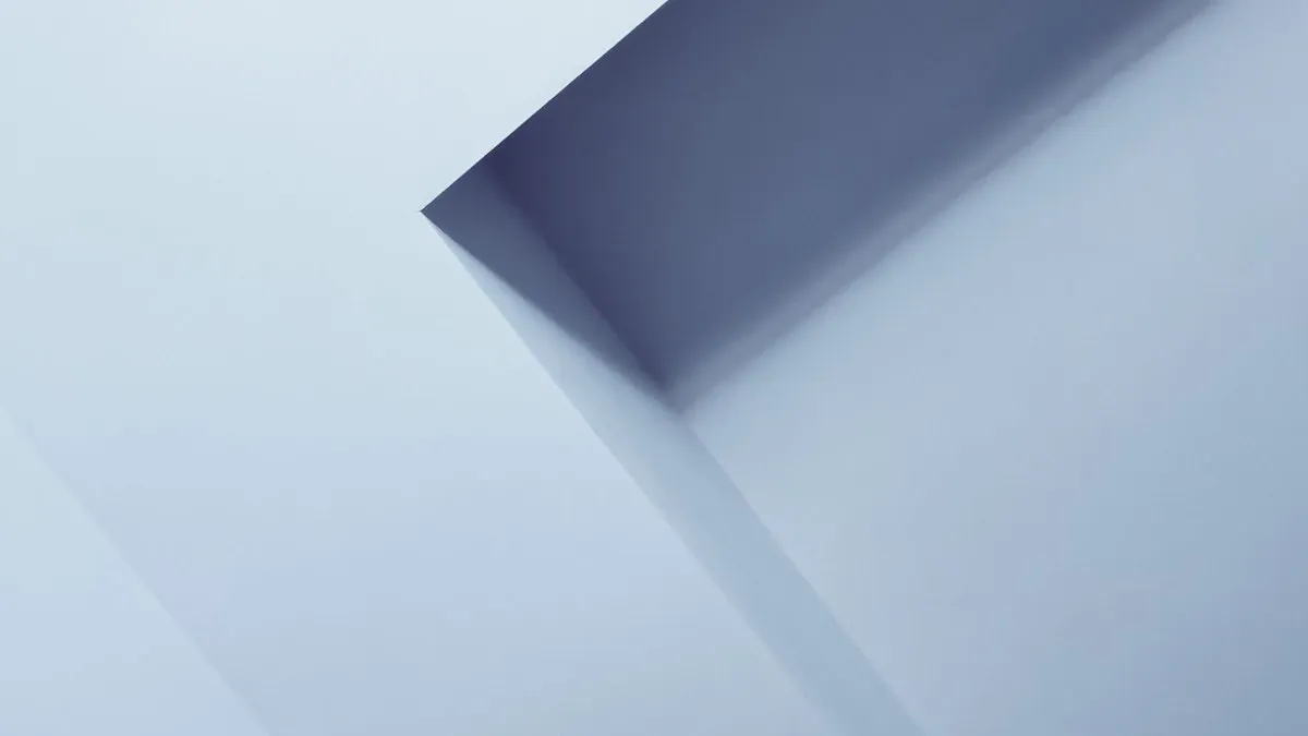 Close-up of abstract architectural elements creating geometric patterns in soft blue tones.