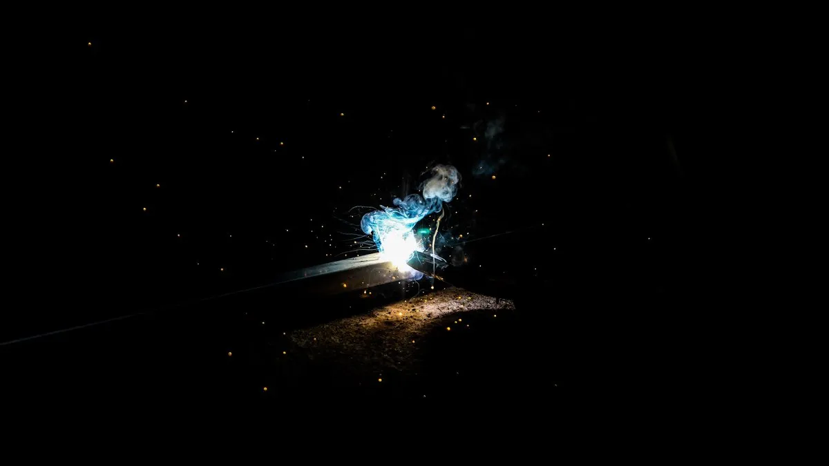 Vivid capture of welding sparks illuminating the night with striking contrast and atmosphere.