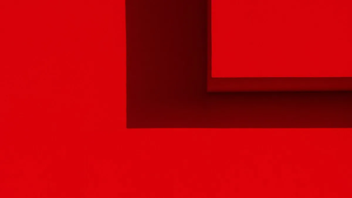 Minimalistic abstract image with geometric shadows and red surfaces creating a bold visual.
